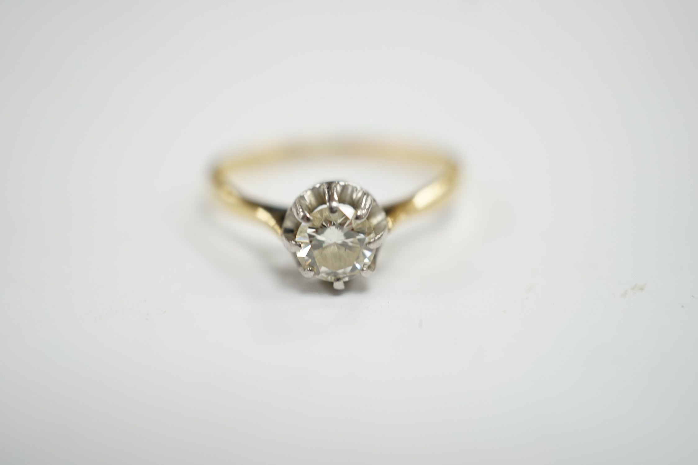 An early 20th century 18ct, plat and claw set solitaire diamond ring, size S, gross weight 2.8 grams.